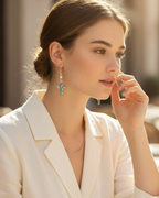 Amelia Jane Handmade Creations abalone shell cross earrings with freshwater pearl and S925 posts worn by a woman