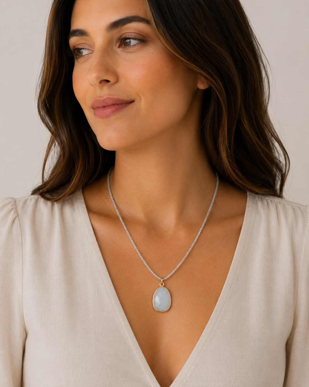 Amelia Jane Handmade Creations faceted blue apatite beaded necklace with a smooth oval amazonite pendant on a model.