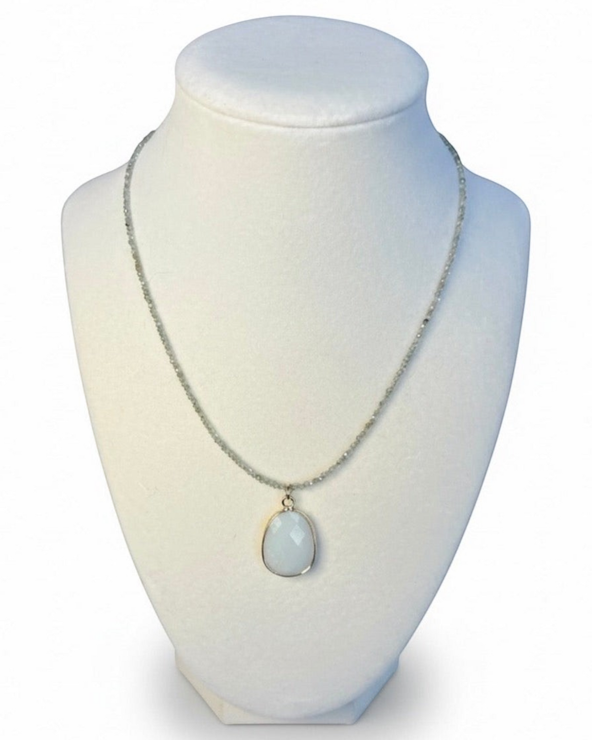 Amelia Jane Handmade Creations faceted apatite beaded necklace with a smooth oval amazonite pendant on a display bust