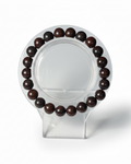 Amelia Jane Handmade Creations 7-inch bloodstone jasper beaded bracelet on a clear display stand
