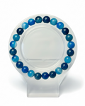 Amelia Jane Handmade Creations 7-inch blue banded agate beaded bracelet on a clear display stand