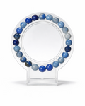Amelia Jane Handmade Creations 7-inch Blue Aventine beaded bracelet on a clear circular display stand