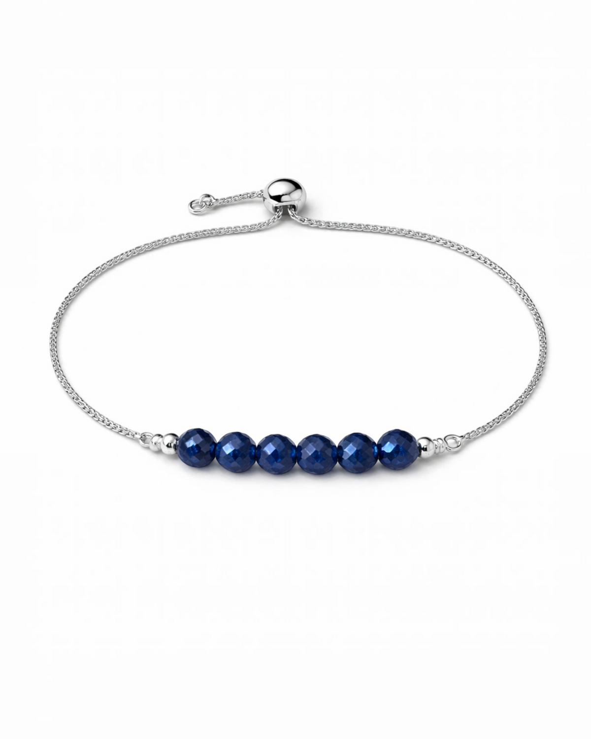 Amelia Jane Handmade Creations blue sapphire lariat bracelet with an adjustable silver chain and faceted beads.
