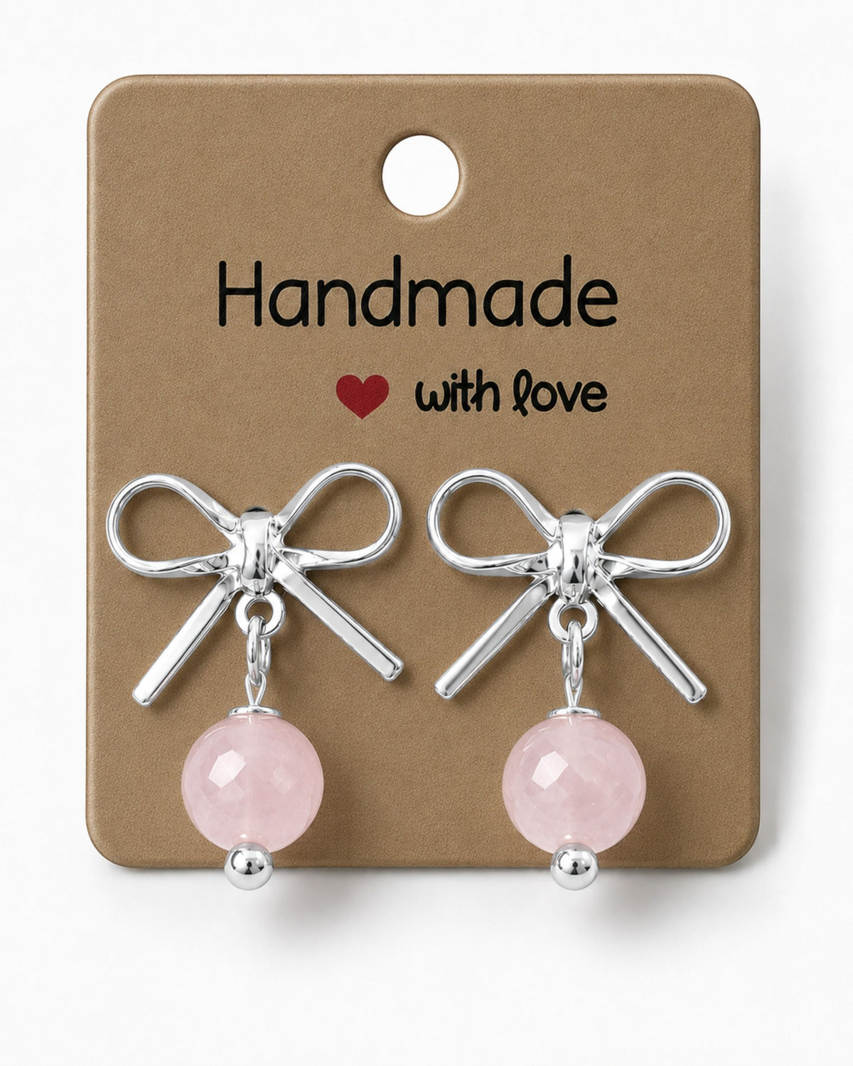 Amelia Jane Handmade Creations platinum plated bow stud earrings with dangling pink rose quartz beads on display card