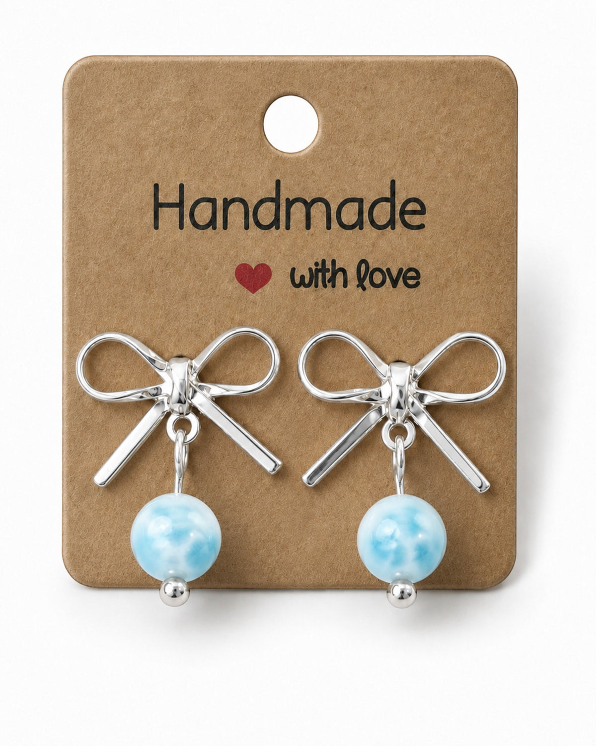Amelia Jane Handmade Creations platinum plated bow stud earrings with dangling blue marbled beads on display card.
