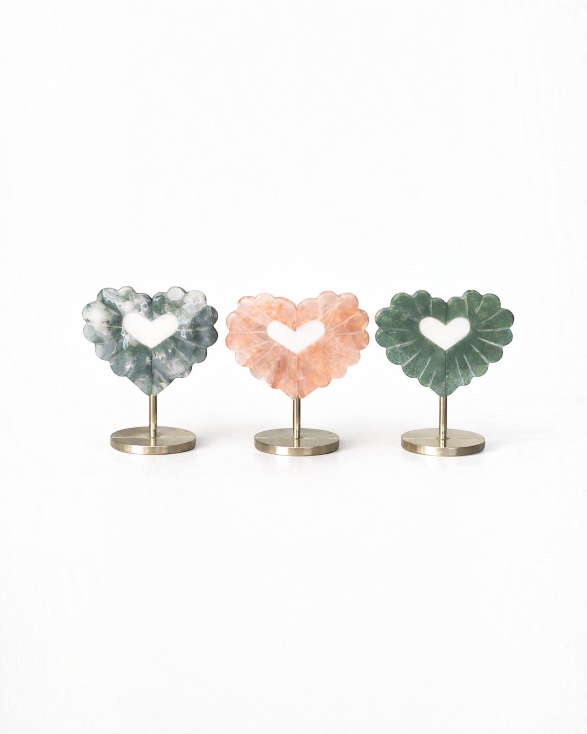 Amelia Jane Handmade Creations carved gemstone heart leaves in moss agate and fire quartz on gold metal stands.