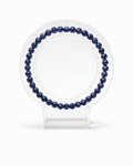 Amelia Jane Handmade Creations 7-inch faceted sodalite gemstone bead bracelet on a clear circular display stand