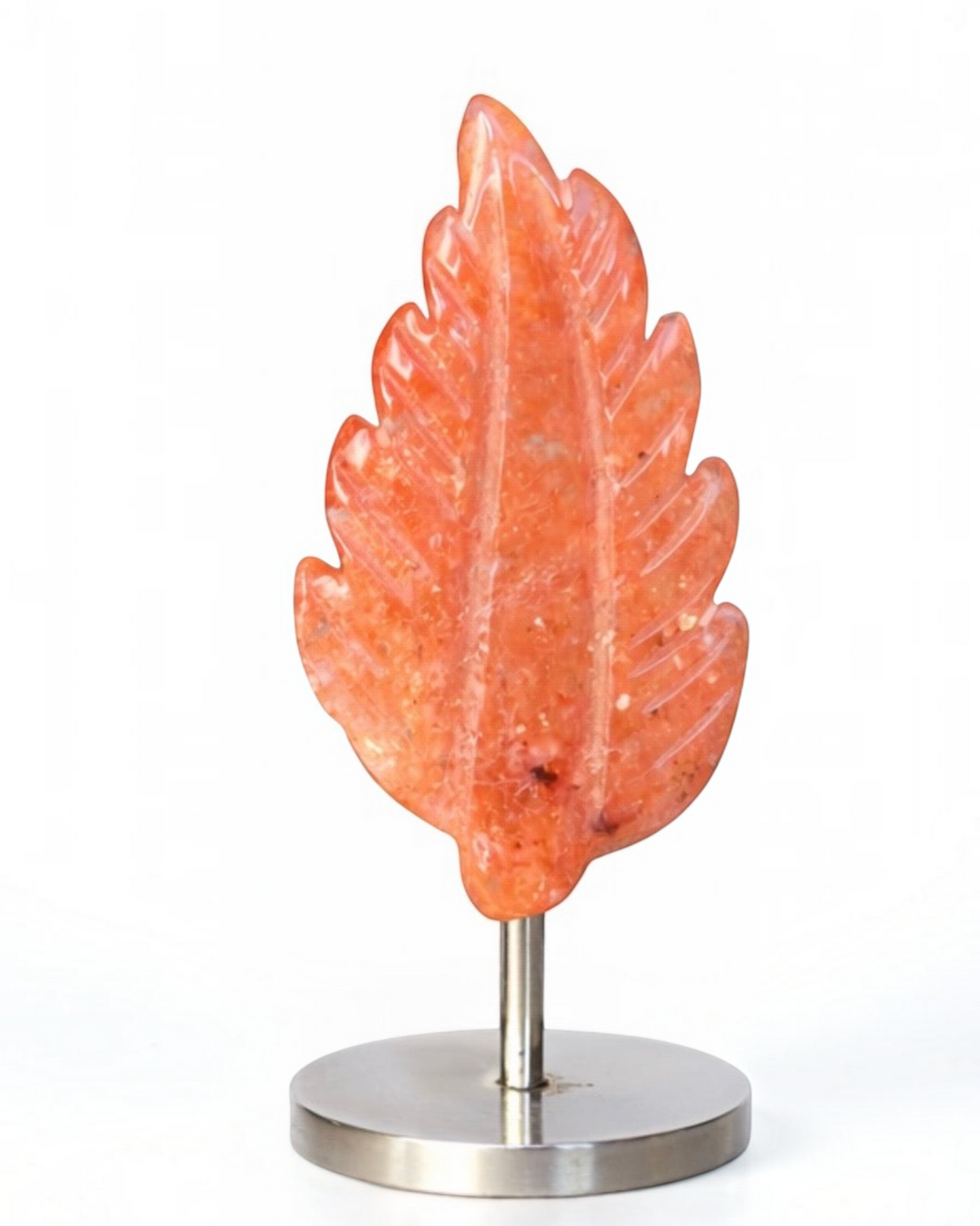 Amelia Jane Handmade Creations fire agate carved feather sculpture with detailed veining on a metal display stand