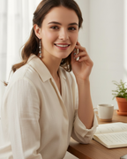 Amelia Jane Handmade Creations freshwater pearl dangle earrings with S925 posts worn by a smiling woman