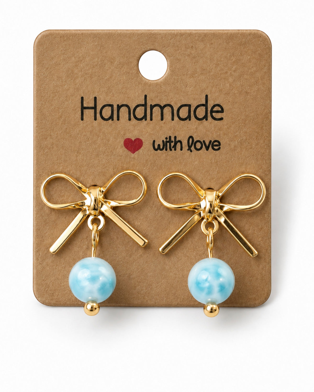 Amelia Jane Handmade Creations gold plated bow stud earrings with dangling light blue marbled beads on display card