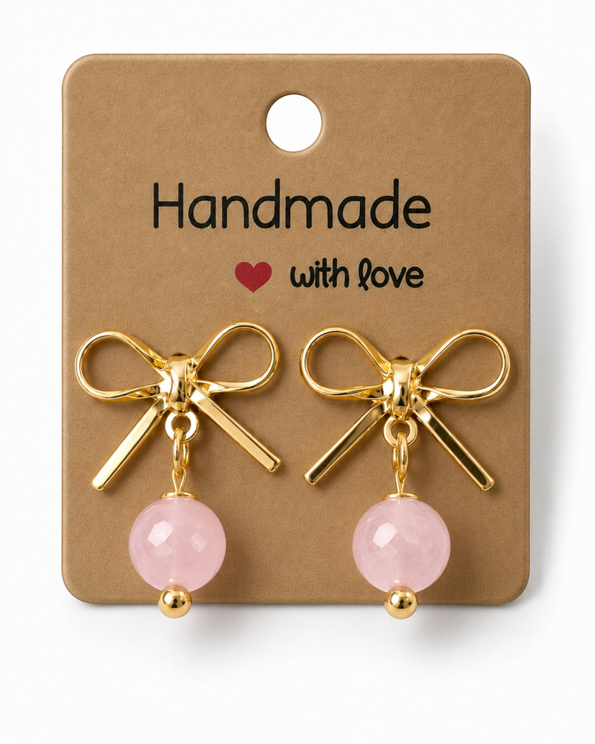 Amelia Jane Handmade Creations gold bow stud earrings with dangling pink rose quartz beads on a display card.