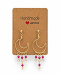 Amelia Jane Handmade Creations wire wrapped gold moon earrings with pink beaded dangles and s925 posts on a display card