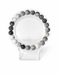 Amelia Jane Handmade Creations 7-inch cloudy gray quartz beaded bracelet on a clear display stand.