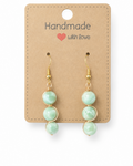 Amelia Jane Handmade Creations green moonstone drop earrings with S925 gold-tone wire wrapping on display card