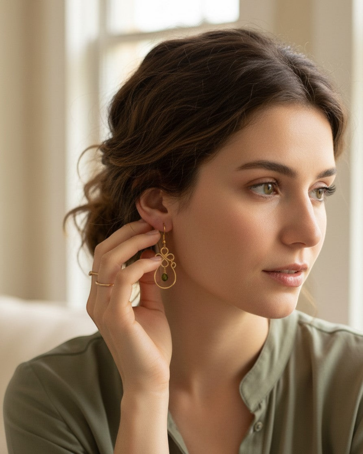 Amelia Jane Handmade Creations green tourmaline teardrop earrings with s925 posts worn by a woman in a soft setting