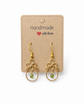 Amelia Jane Handmade Creations green tourmaline teardrop earrings with gold wire filigree and s925 posts on a card.