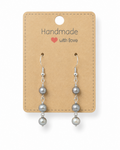 Amelia Jane Handmade Creations freshwater pearl dangle earrings with S925 silver posts on a kraft display card.