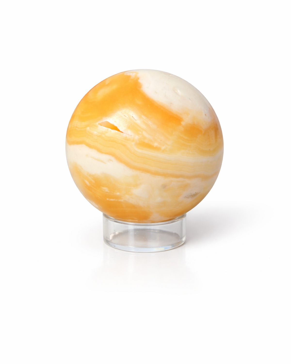 Amelia Jane Handmade Creations polished honey calcite crystal sphere with yellow and cream swirls on a clear stand.