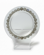 Amelia Jane Handmade Creations 7-inch beaded bracelet featuring round grey labradorite gemstones on a clear stand.