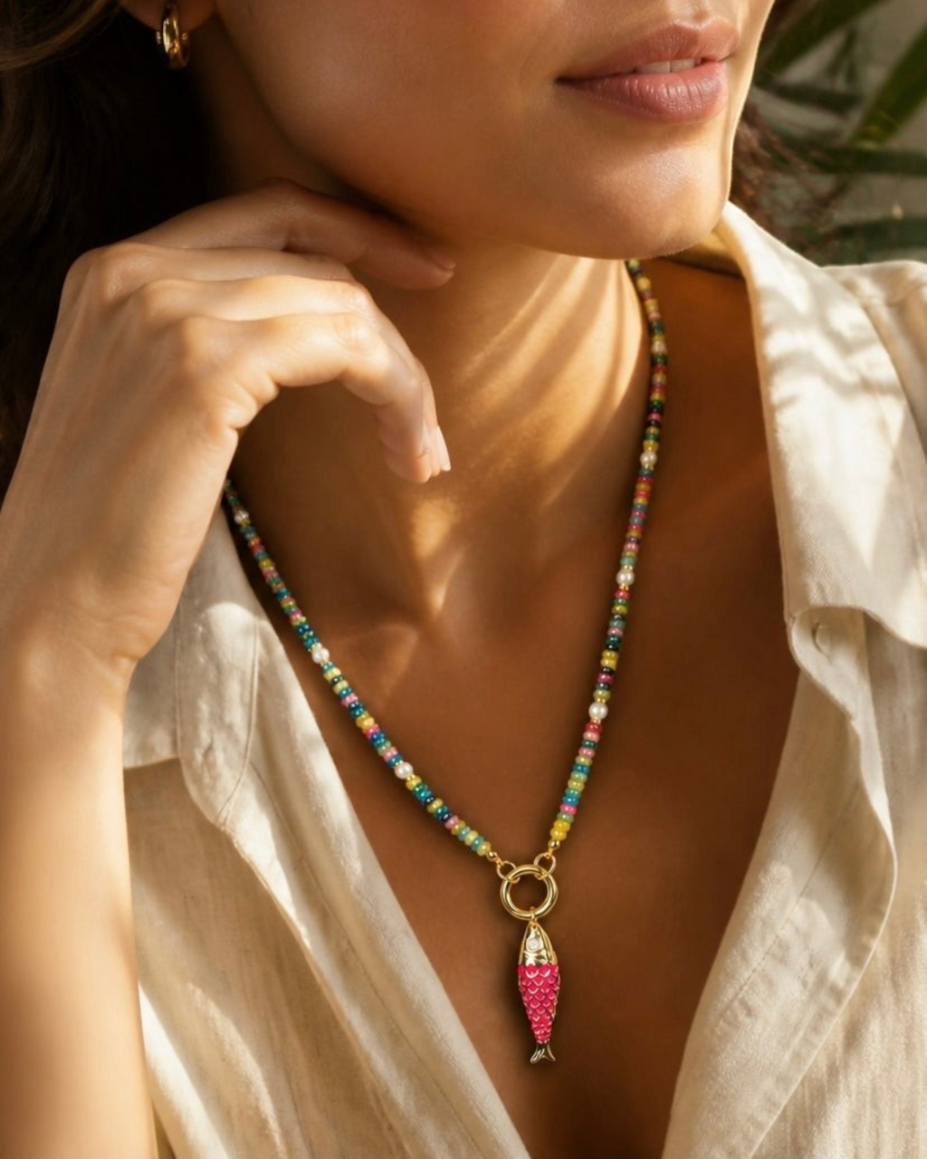 Amelia Jane Handmade Creations Lucky Catch necklace featuring a pink fish charm, multicolored jade, and pearls.