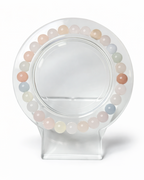Amelia Jane Handmade Creations 7-inch beaded morganite bracelet with soft pastel gemstone hues on a clear stand