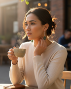 Amelia Jane Handmade Creations moss agate drop earrings with S925 posts worn by a woman holding a steaming coffee cup.