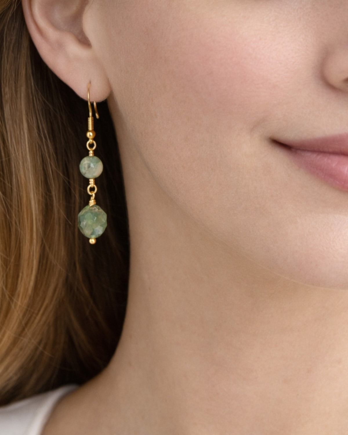 Amelia Jane Handmade Creations moss agate drop earrings with faceted green stones and gold s925 posts on a model