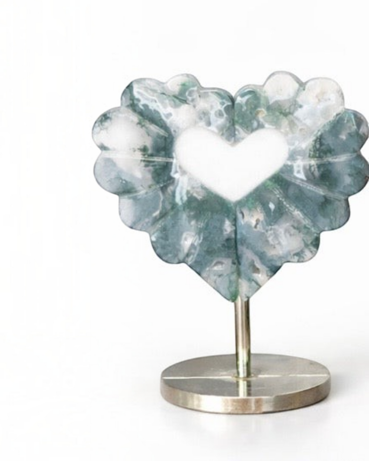 Amelia Jane Handmade Creations moss agate heart leaf carving with intricate details displayed on a metal stand.