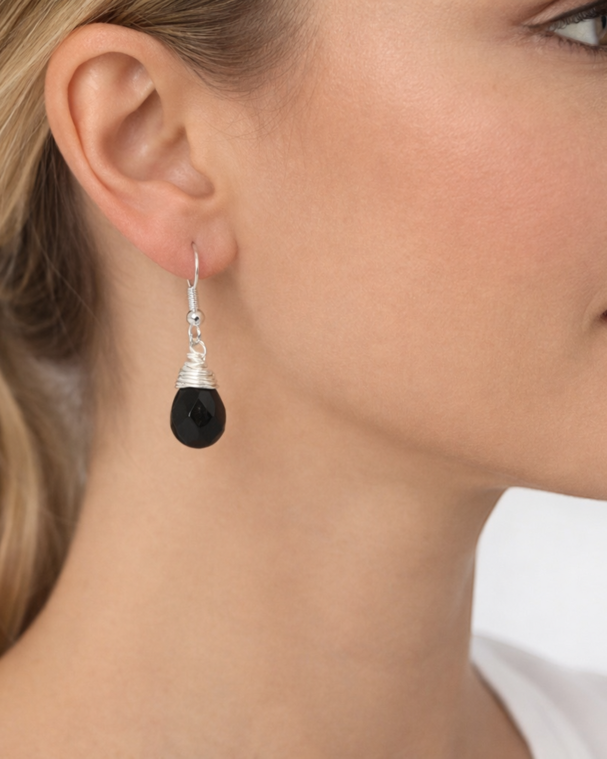 Amelia Jane Handmade Creations obsidian teardrop earrings with s925 silver wire-wrapped posts worn by a woman