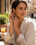 Amelia Jane Handmade Creations freshwater pearl and blue apatite drop earrings with S925 posts worn by a woman