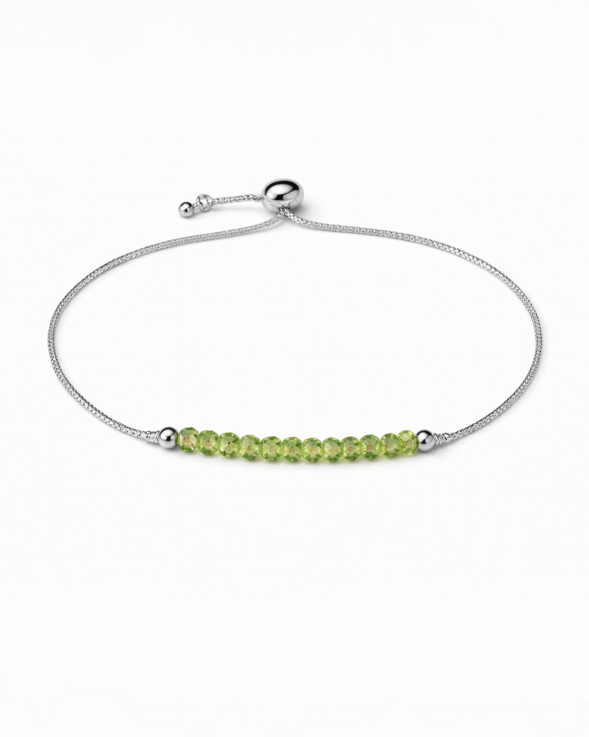 Amelia Jane Handmade Creations adjustable lariat bracelet featuring small green peridot beads on a silver chain.
