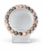 Amelia Jane Handmade Creations 7-inch pink zebra jasper beaded bracelet on a clear display stand