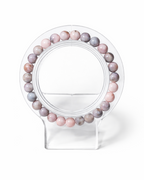 Amelia Jane Handmade Creations 7-inch Pink Zebra Jasper beaded bracelet on a clear acrylic display stand.