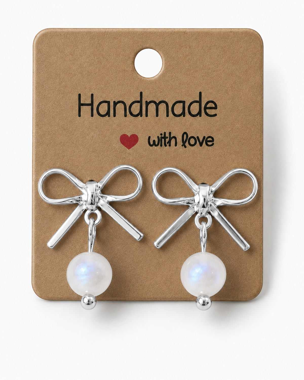 Amelia Jane Handmade Creations platinum plated bow stud earrings with dangling white moonstone beads on display card