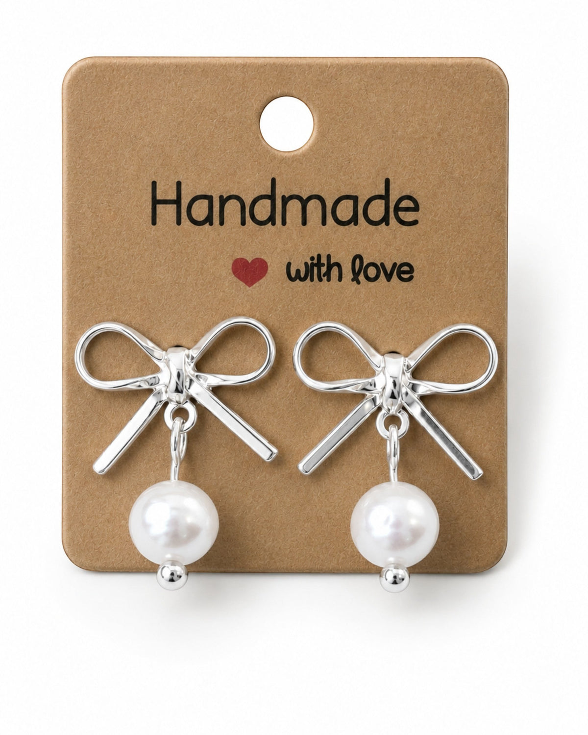 Amelia Jane Handmade Creations platinum plated bow stud earrings with dangling white pearls on a display card.