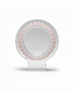 Amelia Jane Handmade Creations 7-inch rose quartz beaded bracelet displayed on a clear circular stand