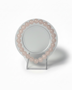 Amelia Jane Handmade Creations 7-inch beaded bracelet made of smooth, pale pink rose quartz gemstones.