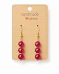 Amelia Jane Handmade Creations ruby dangle earrings with S925 posts and gold-tone accents on a display card