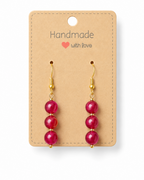 Amelia Jane Handmade Creations ruby dangle earrings with S925 posts and gold-tone accents on a display card