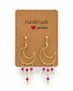 Amelia Jane Handmade Creations Ruby Moon earrings with gold wire crescent moons and dangling ruby bead accents.