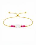 Amelia Jane Handmade Creations lariat bracelet with a white mother of pearl rose, pink ruby beads, and gold chain.