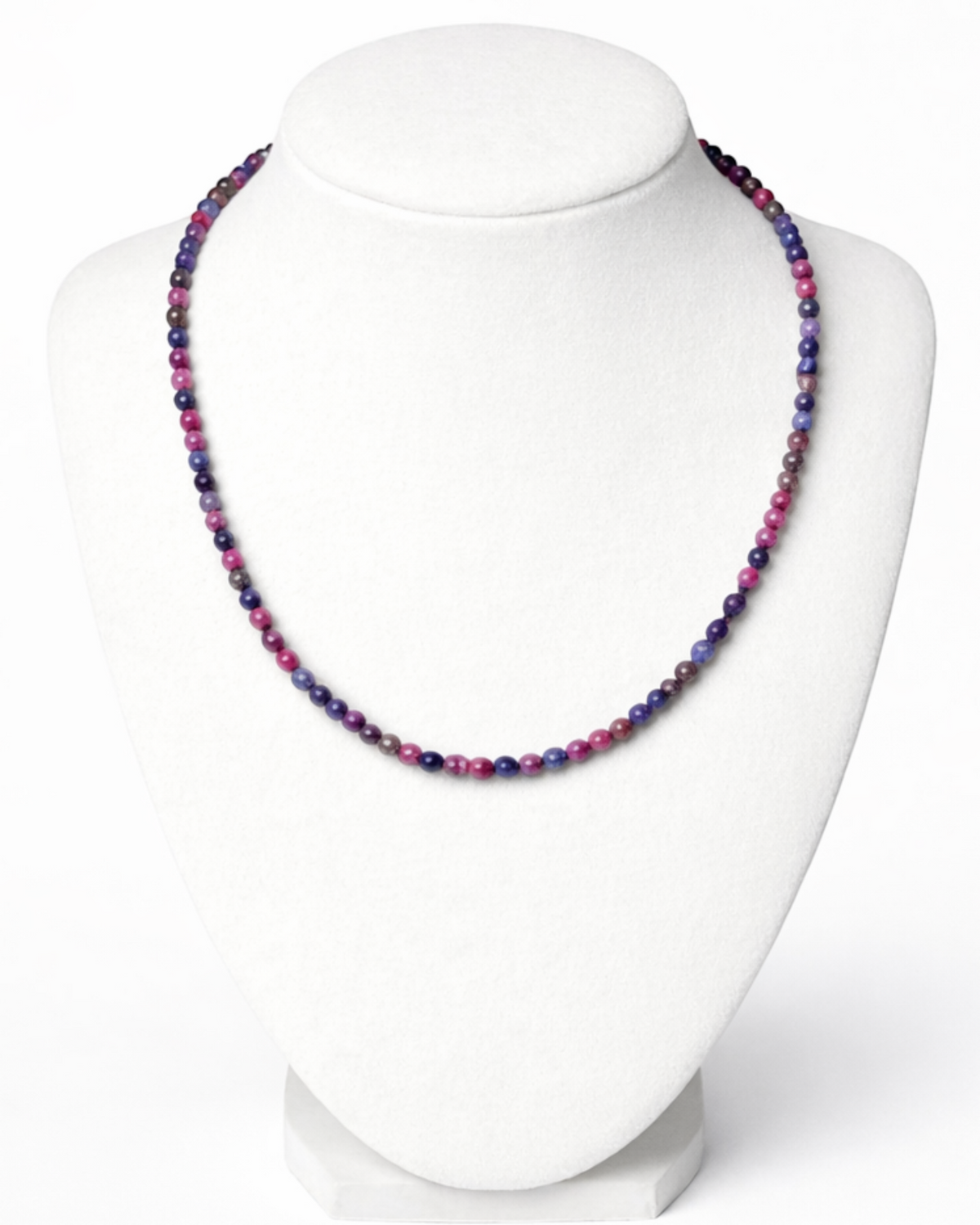 Amelia Jane Handmade Creations faceted ruby and blue sapphire beaded necklace on a white display bust.