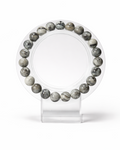 Amelia Jane Handmade Creations 7-inch beaded bracelet featuring natural silver Picasso jasper stones on a display stand.