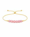 Amelia Jane Handmade Creations strawberry quartz lariat bracelet with faceted pink beads and adjustable gold chain.