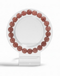 Amelia Jane Handmade Creations 7-inch strawberry quartz beaded bracelet on a clear display stand