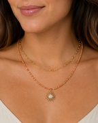 Amelia Jane Handmade Creations Golden Hour necklace featuring sunstone beads, gold hematite, and a sunburst pendant.