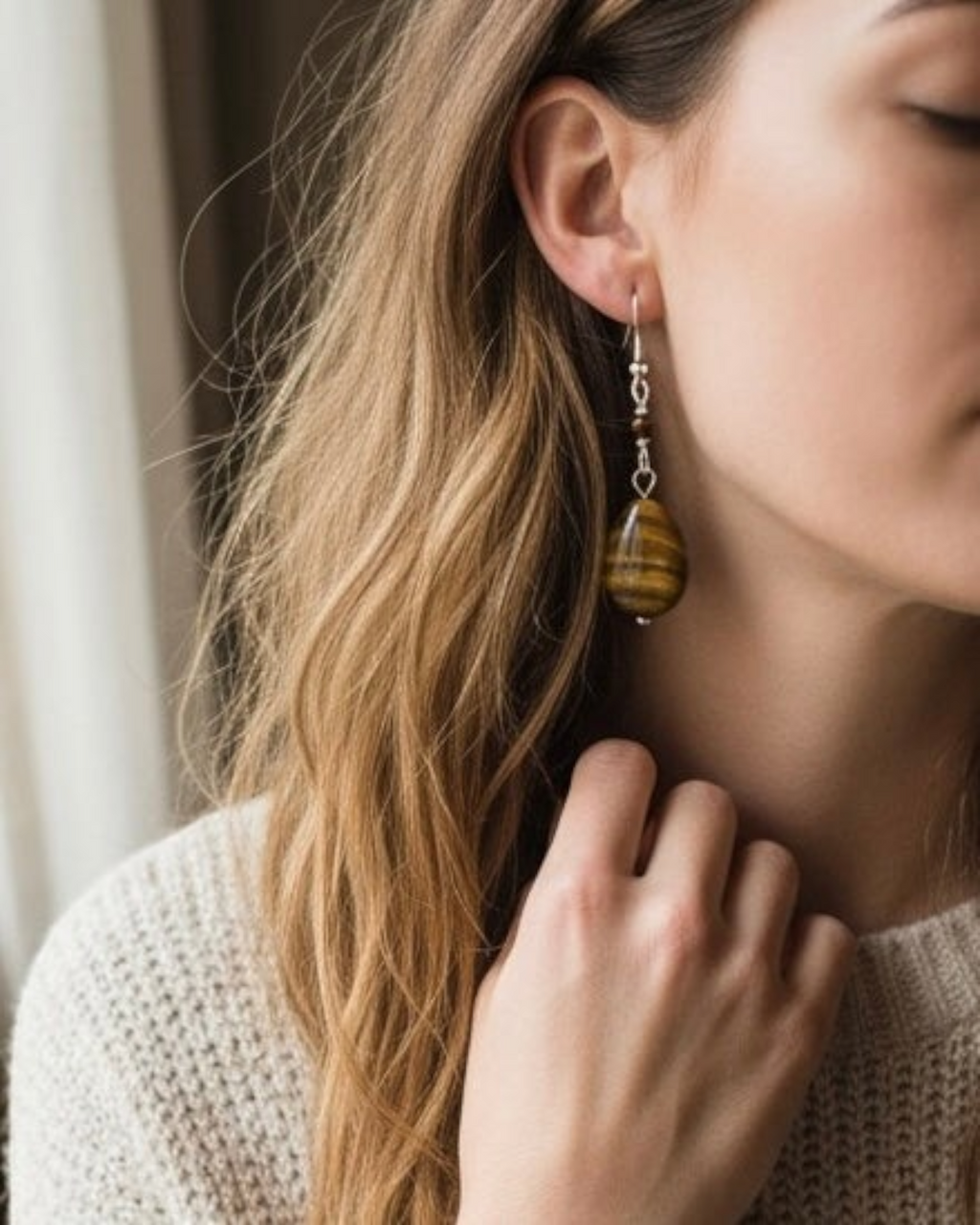 Amelia Jane Handmade Creations tiger eye teardrop earrings with S925 silver posts worn by a woman