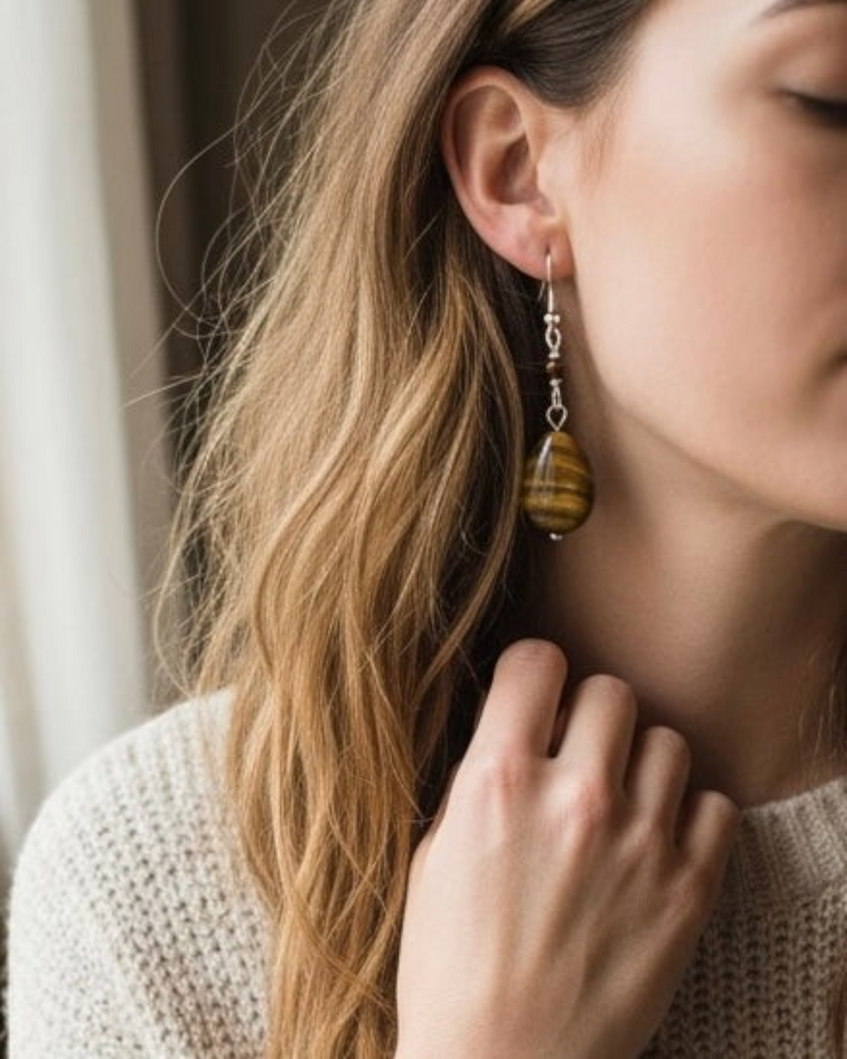Amelia Jane Handmade Creations tiger eye teardrop earrings with S925 silver posts worn by a woman
